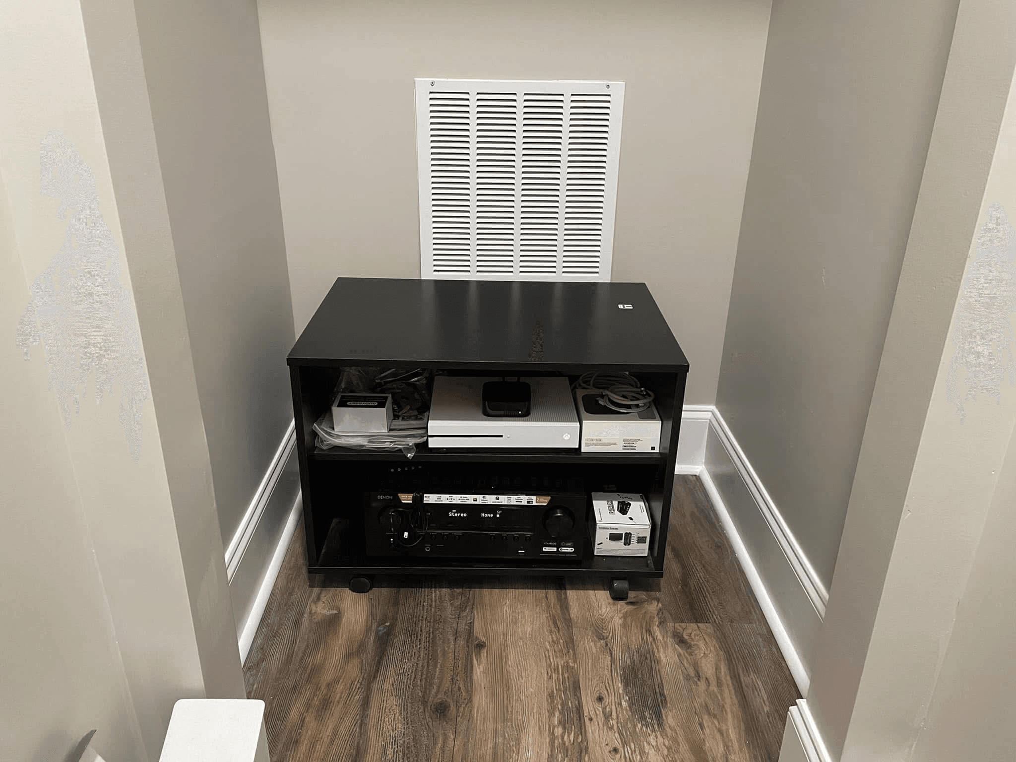 AV equipment closet with receiver, streaming devices, and organized cabling