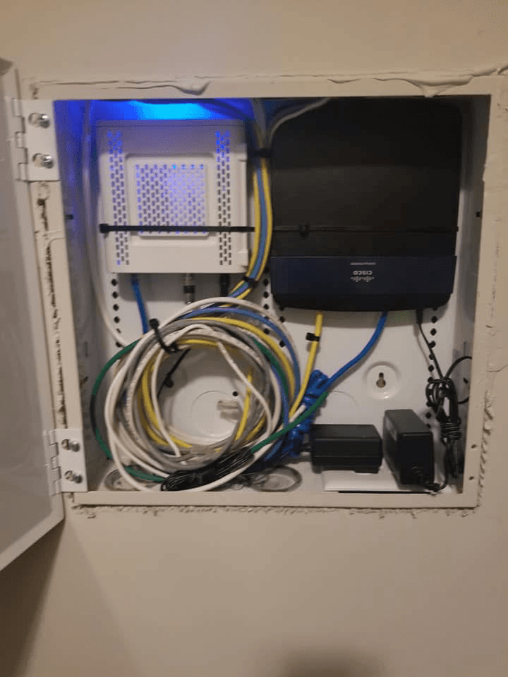 Network enclosure with Cisco router and patch cables