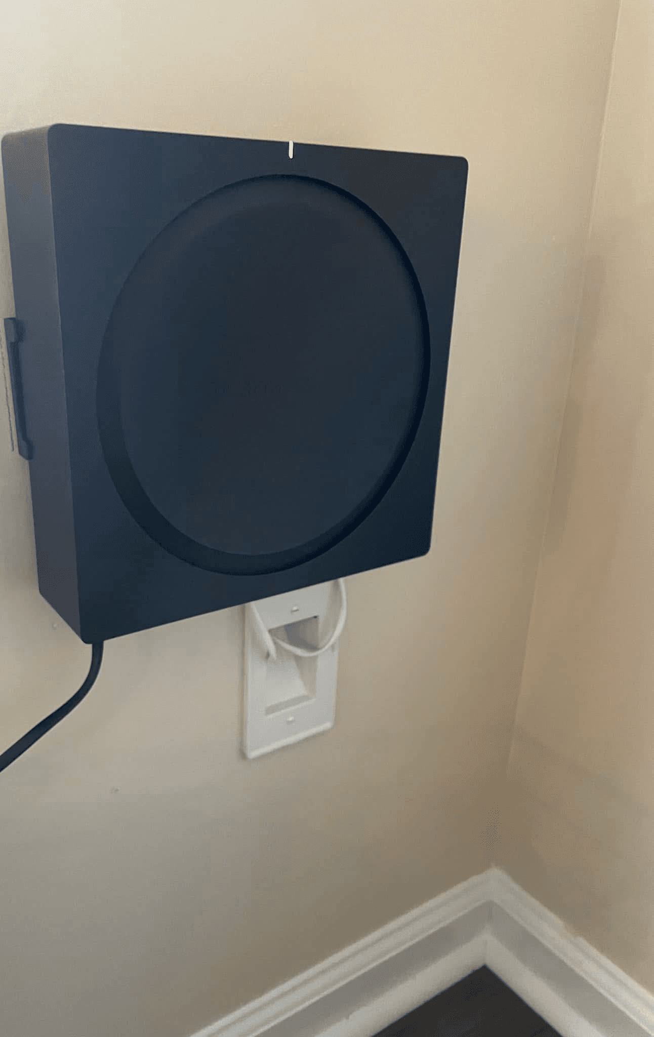 Sonos Sub wall-mounted above power outlet with clean cable management